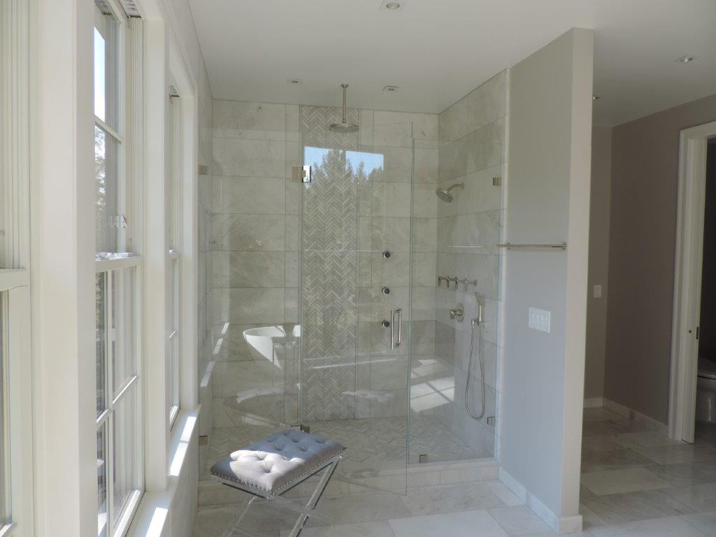 A shower with multiple shower heads constructed by Twin Brook Construction.