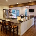 A large kitchen with a custom home addition family room built behind it