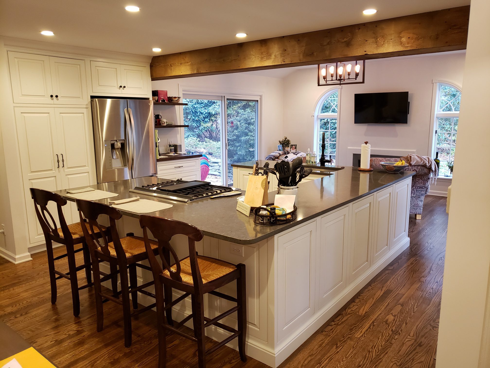 A large kitchen with a custom home addition family room built behind it
